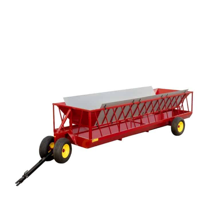 Side view of a Farmco VersaFeed cattle feeder featuring a red frame with a V-shaped divider and galvanized feed cover.