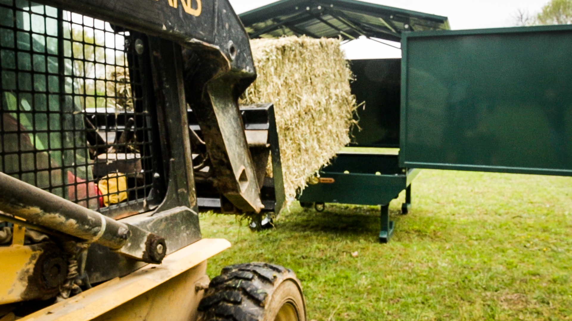 exterior photo of skid loader with hay for why horses pee on their hay post