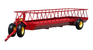 A cattle feeder on wheels for feeding hay bales and chopped feeds